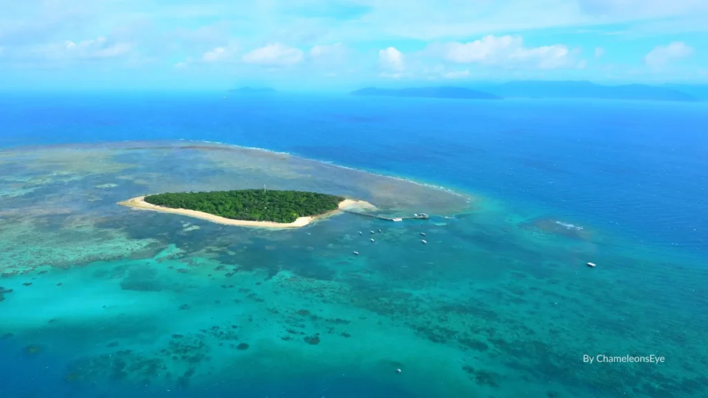 Aerial view of Green Island surrounded by coral reef and turquoise waters, Great Barrier Reef near Cairns, Queensland.