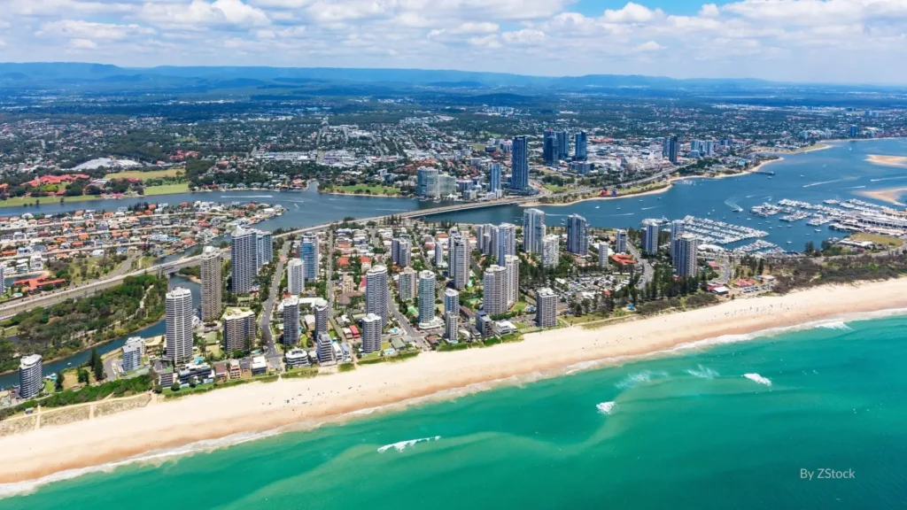Aerial view of Main Beach with golden sand, turquoise waves, marina, and high-rise apartments along the Gold Coast, Queensland, Australia.