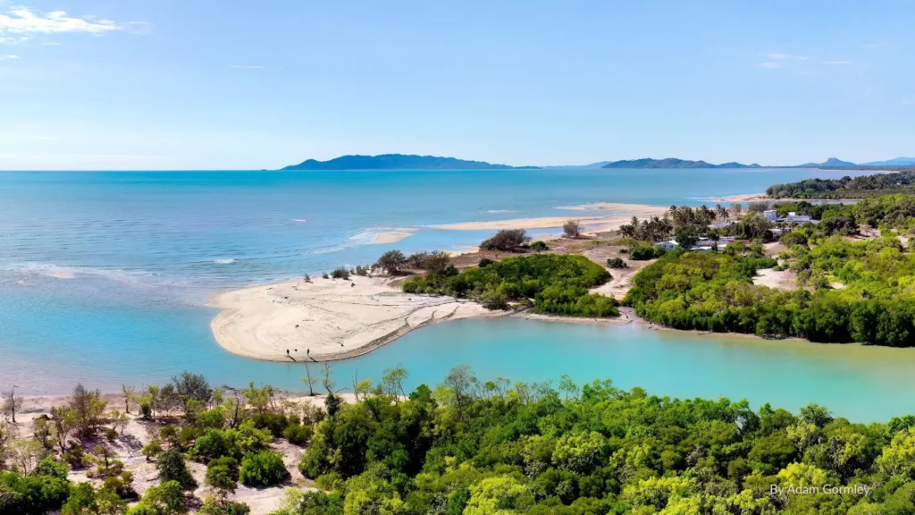Scenic view of Saunders Beach with turquoise waters, sandy shoreline, and lush greenery just north of Townsville, Queensland.