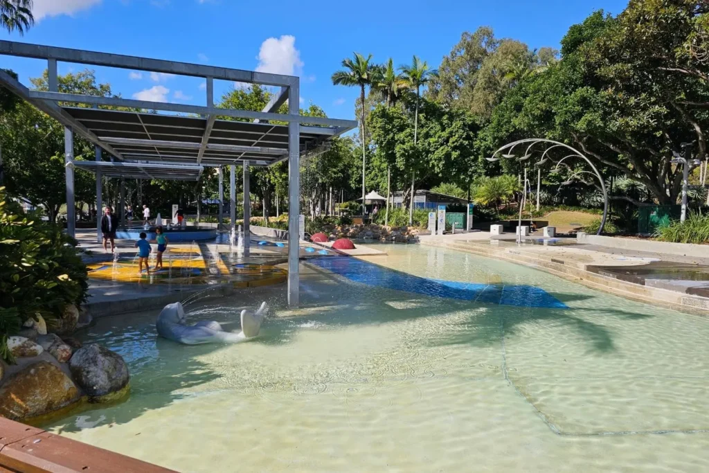 Aquativity kids’ water play area, South Bank Parklands Brisbane — shallow splash zone beside Streets Beach with shade structures, family-friendly attraction.