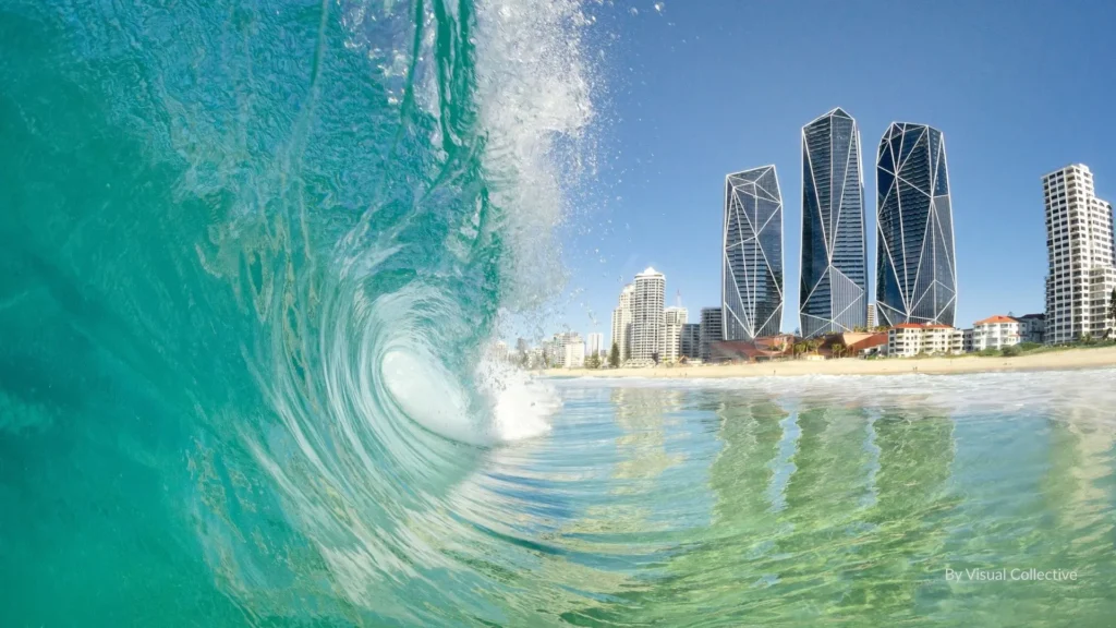Breaking turquoise wave with the Surfers Paradise skyline in the background on the Gold Coast, Queensland, capturing the city’s famous surf and beach lifestyle.