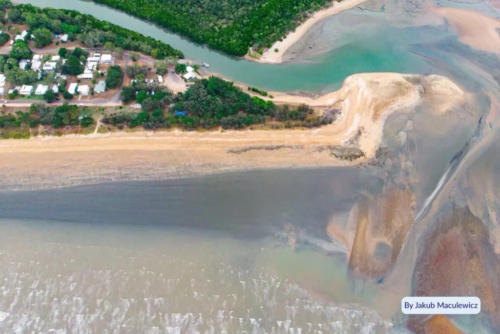 Drone view of Balgal Beach showing the river mouth and mangrove estuary meeting the Coral Sea, Queensland