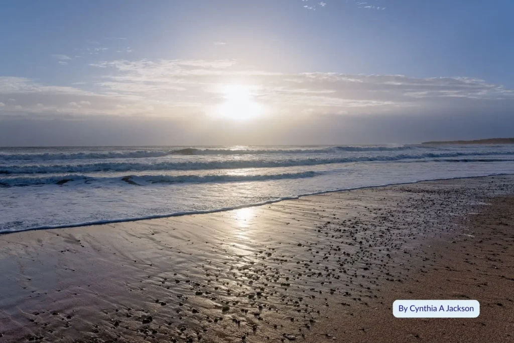 Sunrise over Burnett Heads Beach in Bundaberg, Queensland, with gentle waves washing over the sandy shoreline along the Coral Coast.