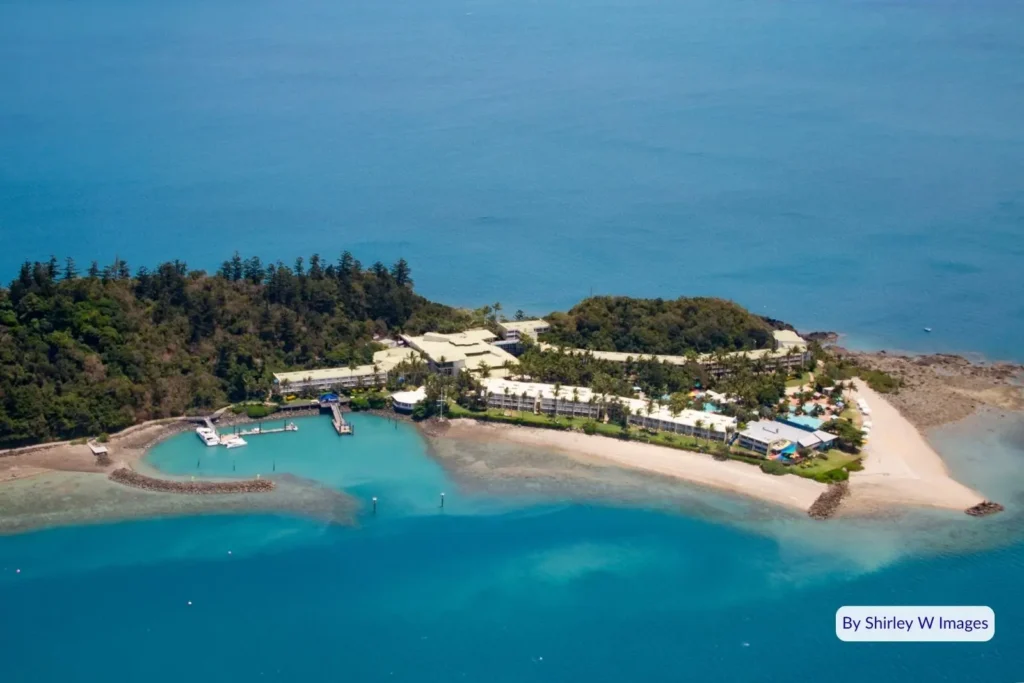 Aerial view of Daydream Island Resort surrounded by coral reef lagoon and turquoise waters in the Whitsundays, Great Barrier Reef, Queensland.