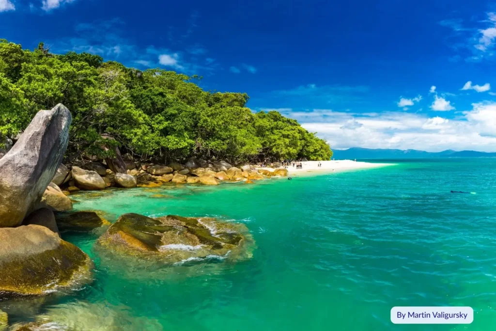 Vibrant turquoise sea and rocky rainforest headland at Fitzroy Island, part of the Great Barrier Reef near Cairns, Queensland, Australia