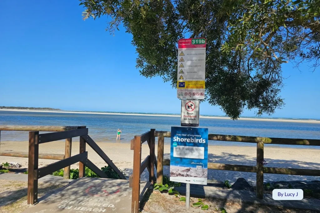 Beach access ramp and information signs near the tranquil waters of Golden Beach, Caloundra, Sunshine Coast, Queensland.