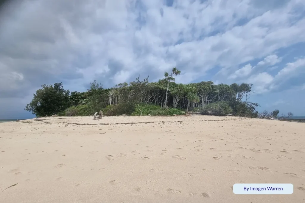 Golden sandy beach and lush rainforest on Green Island surrounded by turquoise coral waters, Great Barrier Reef, Queensland, Australia