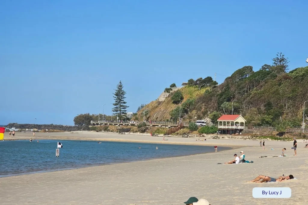Panoramic view from Greenmount Hill overlooking Coolangatta Beach and Kirra Point with sparkling afternoon sunlight on the ocean, Gold Coast, Queensland