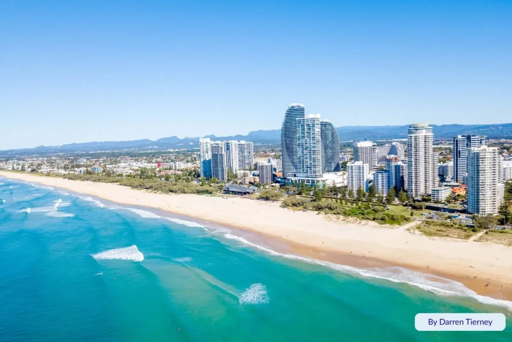 Aerial view of Kurrawa Beach at Broadbeach, Gold Coast, Queensland, with turquoise water, golden sand, and the iconic Oracle Towers along the beachfront skyline.