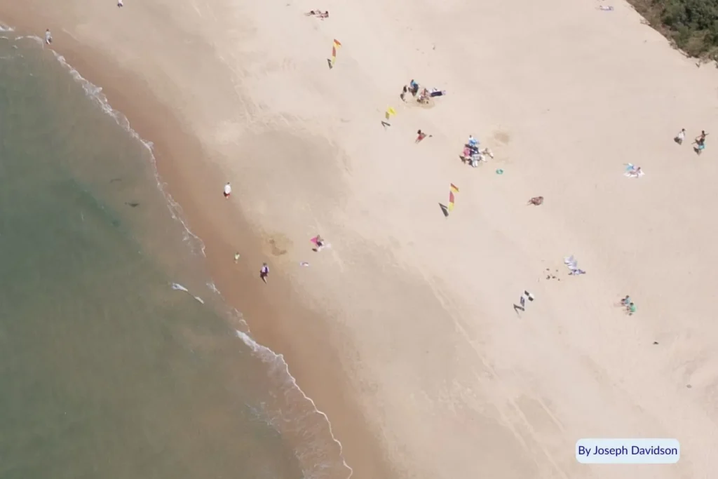 Aerial view of beachgoers relaxing on the golden sand at Maroochydore Beach, Sunshine Coast, Queensland, Australia