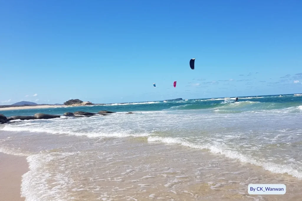 Kitesurfers gliding over turquoise waves at Maroochydore Beach, Sunshine Coast, Queensland
