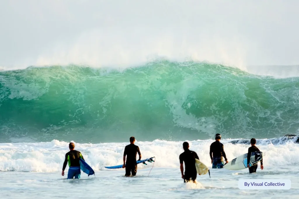 Surfers entering the ocean at Snapper Rocks facing powerful green waves, showcasing one of Australia’s most iconic surf spots on the Gold Coast.