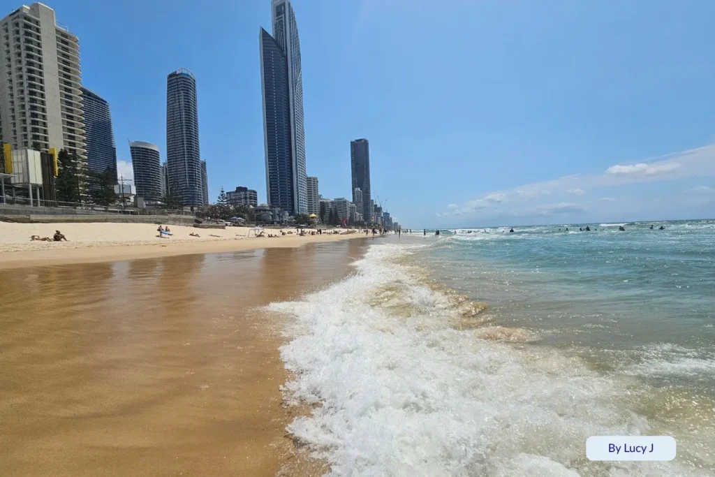 Waves washing onto the shoreline at Surfers Paradise Beach with high-rise towers and Q1 building in the background, Gold Coast, Queensland, Australia