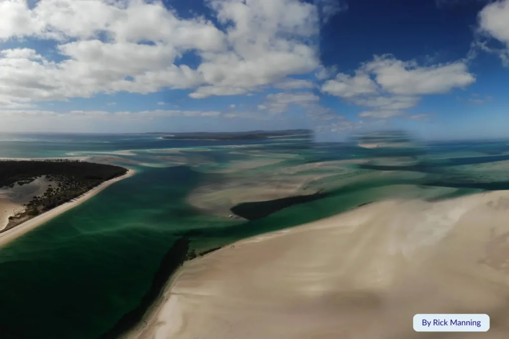 Aerial view of turquoise tidal channels and white sandbanks at Moreton Island, Queensland, showing the stunning coastal landscape and clear shallow waters