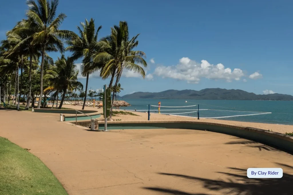 Palm-lined walkway along The Strand foreshore overlooking Magnetic Island and Coral Sea, Townsville, Queensland.