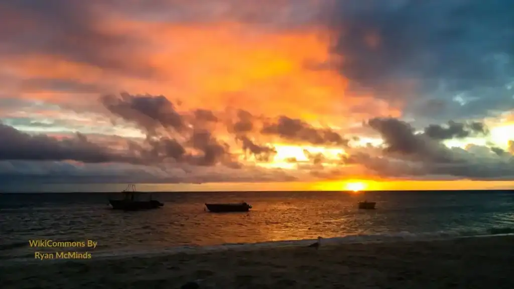 Sunset over the beach and boats at Lizard Island Great Barrier Reef