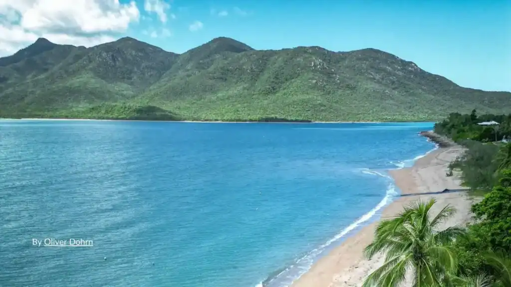 Aerial view of tropical beach and green mountains near Palm Cove northern beaches