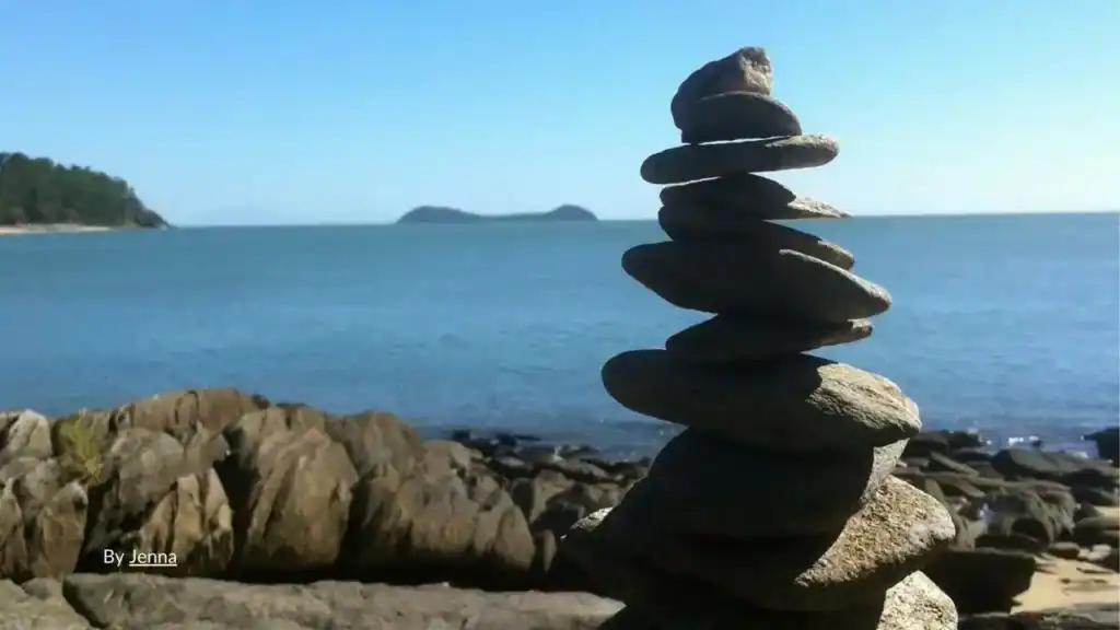 Balanced rock cairn on rocky foreshore at Trinity Beach northern beaches
