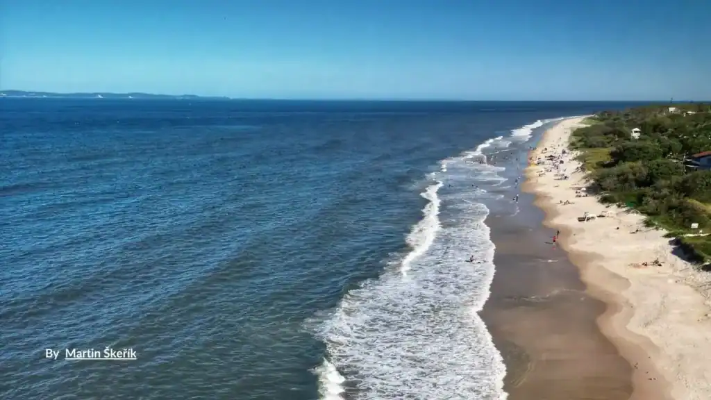 Long aerial view of Yorkeys Knob Beach and Coral Sea waves