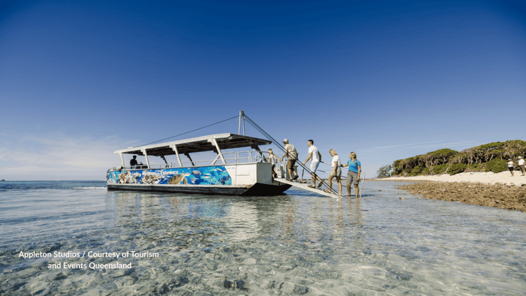 Guests leaving a Lady Musgrave Experience boat on a Lady Musgrave Island day trip in Queensland