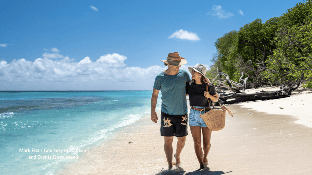 Couple walking the beach at Lady Musgrave Island Queensland