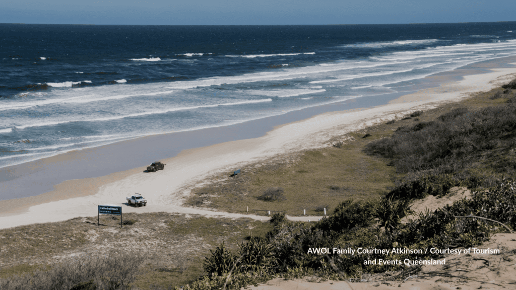 4WD vehicles driving onto Cathedral Beach K'gari Queensland