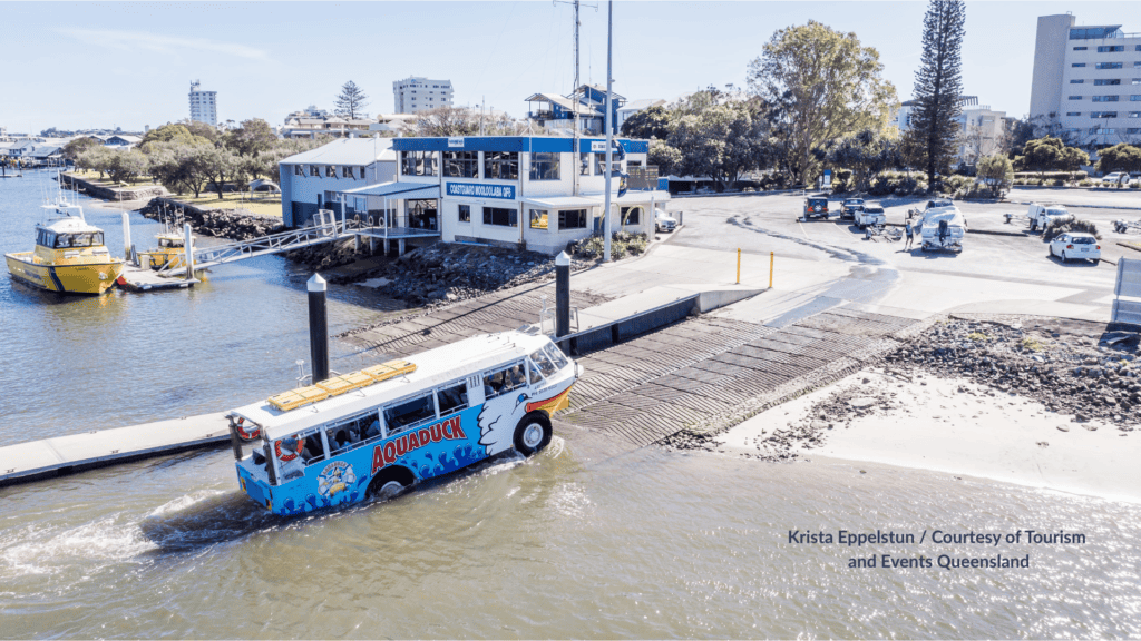 Aquaduck amphibious tour vehicle launching into Mooloolaba Harbour Queensland from the boat ramp beside the Coastguard building