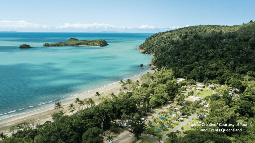 Aerial view of Cape Hillsborough Beach Mackay Queensland with the palm lined campground, rainforest headland and two offshore islands in turquoise water