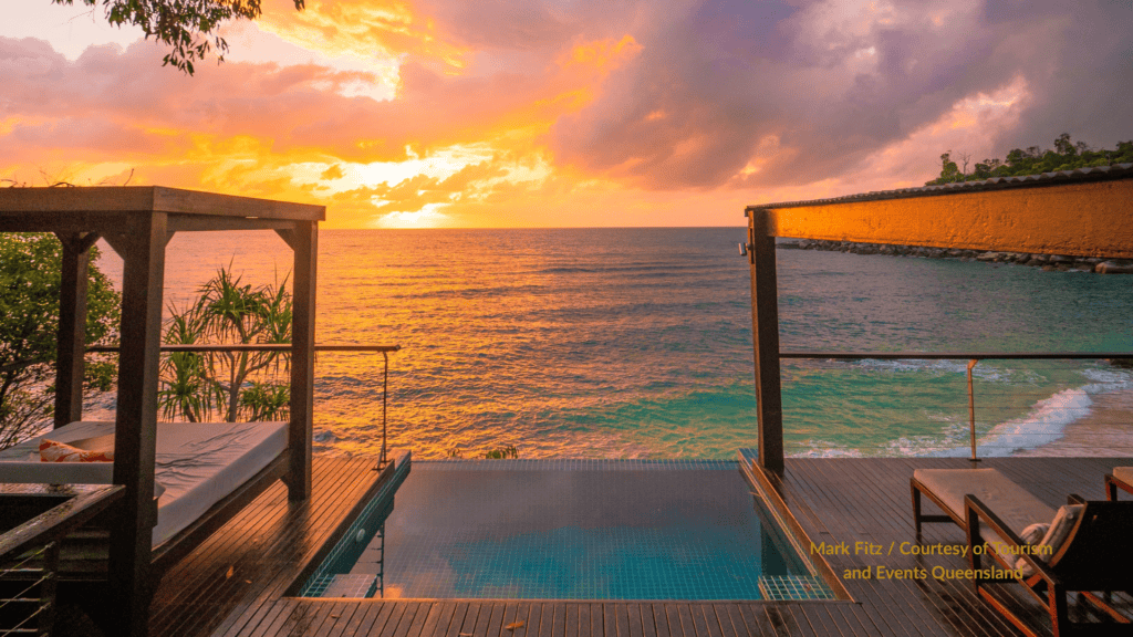 Sunset over the ocean from a villa deck and plunge pool at Bedarra Island near Mission Beach Queensland