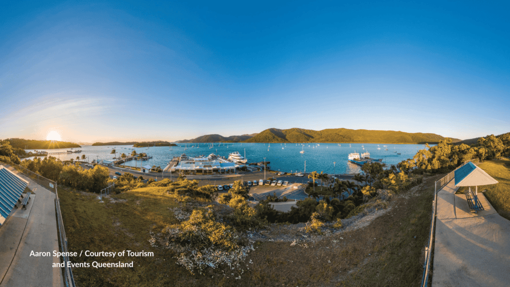 Sunset over Shute Harbour Whitsundays Queensland with the marine terminal yachts and paid parking seen from Lions Lookout