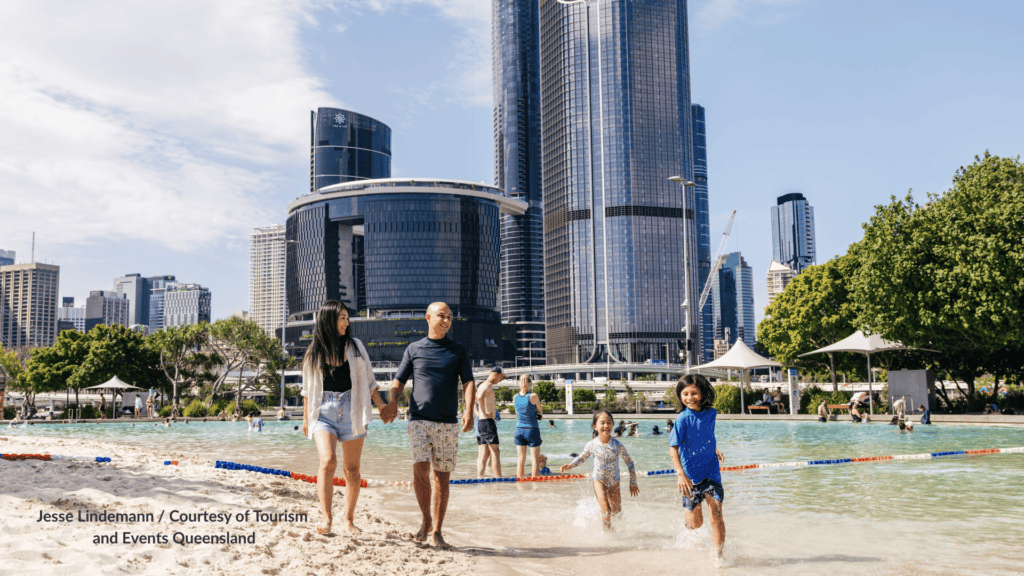 Family walking the sand at Streets Beach Brisbane in the South Bank lagoon Queensland