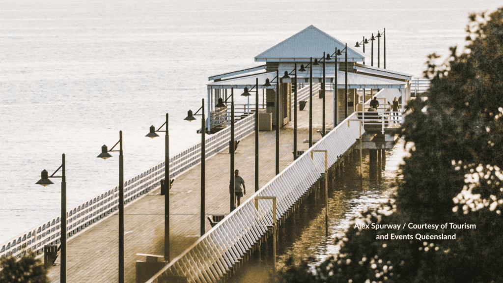 Person walking Shorncliffe Pier at Shorncliffe Beach Brisbane Queensland