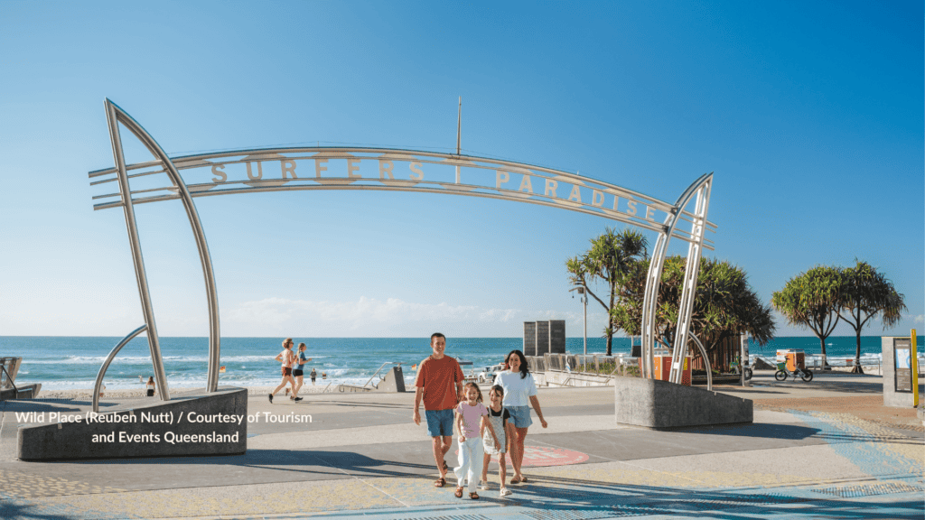 Family walking under the Surfers Paradise arch on Surfers Paradise Beach Queensland