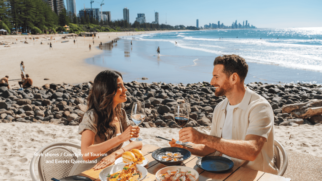 Couple dining at Rick Shores on Burleigh Heads Beach Gold Coast Queensland