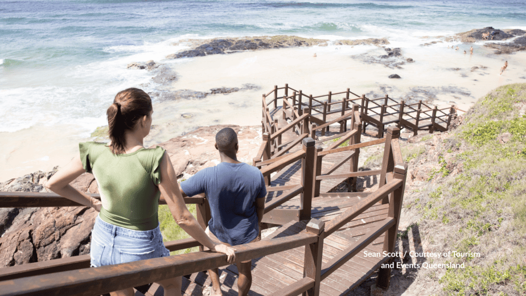 Couple on the stairs at Champagne Pools on Kgari Fraser Island Queensland