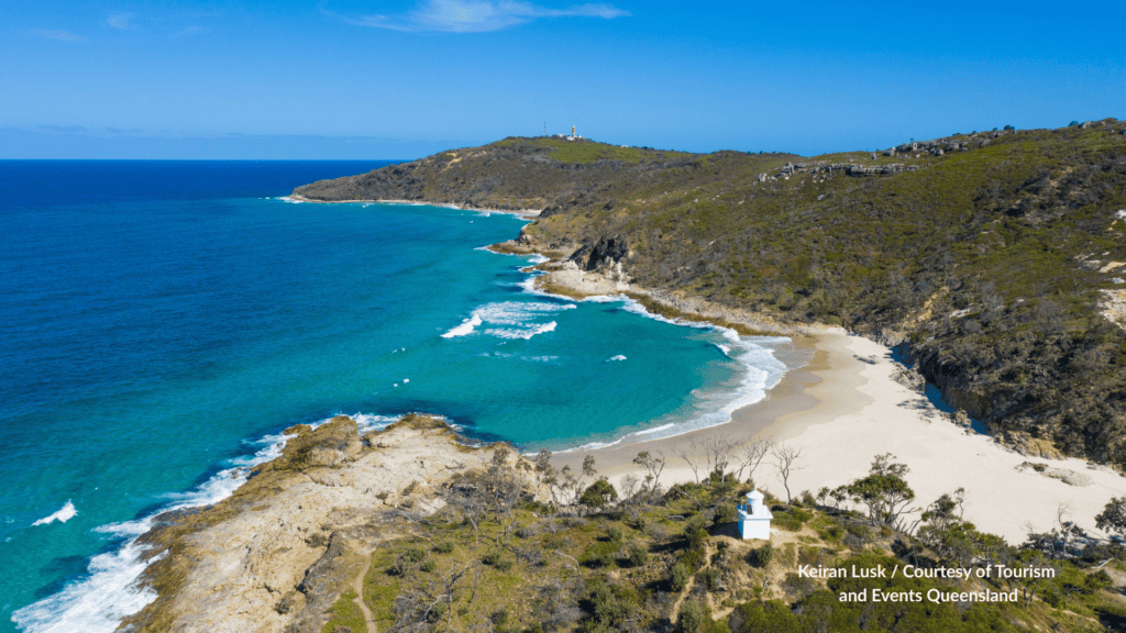 Aerial view of Honeymoon Bay at North Point on Moreton Island Queensland, with North Point Light in the foreground and Cape Moreton Lighthouse on the headland