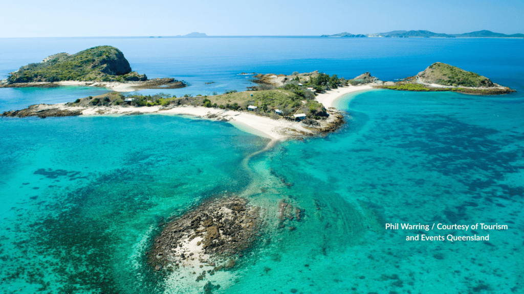 Aerial view of Pumpkin Island with sand spits cabins and reef in Queensland