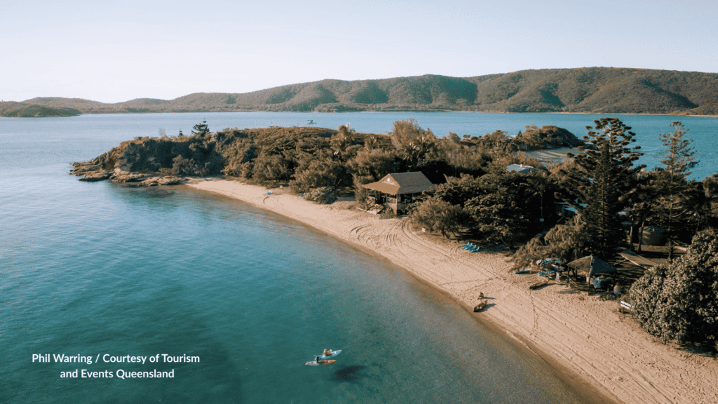Kayakers and beach cabins on Pumpkin Island Queensland