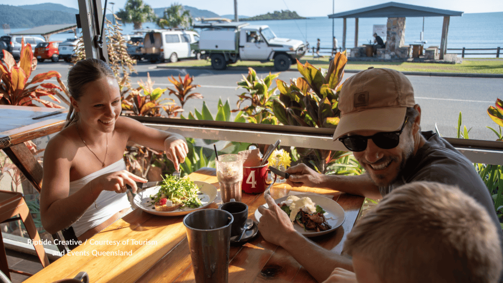 Family enjoying a waterfront breakfast at Cannonvale Beach Queensland